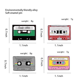 Set of 4 vintage cassette tape enamel pins with Good Vibes text on white background