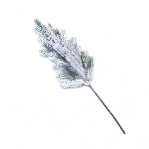 Artificial Christmas cedar branch with faux snow for festive tabletop decoration