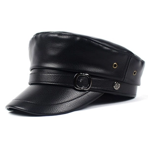 Macro detail of black leather newsboy cap showing metal buckle and stitched texture