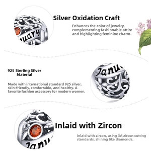 Detail of 925 sterling silver January birthstone charm with orange zircon and engraving