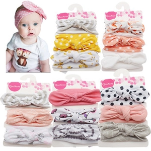 Three-piece infant headband set with various floral and stripe patterns on a display card