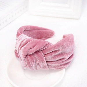 Detail of rose pink velvet knotted headband showing soft fabric texture and elegant twist