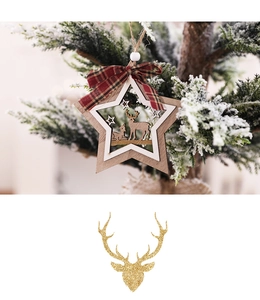 Detail of wooden star ornament with reindeer carving and red plaid bow on Xmas tree