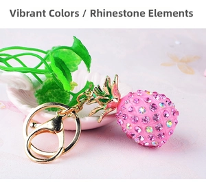 Detailed view of pink rhinestone pineapple keychain with golden clip and metal green leaves