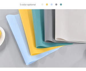 Stack of heat-resistant silicone placemats in five Morandi colors for kitchen dining