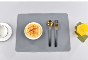 Close-up of a grey rectangular silicone placemat with a minimalist heat-resistant surface