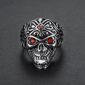 Gothic stainless steel skull ring with red rhinestone eyes and intricate scrollwork