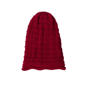 Detailed close-up of dark red knitted beanie with square checkered texture and ribbed cuff