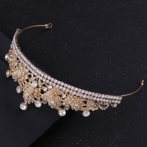 Detail of bridal gold alloy crown featuring intricate leaf design and sparkling rhinestones