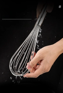 Macro detail of stainless steel whisk wires with water splashes on dark background