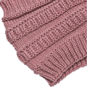 Detailed macro view of the soft dusty pink cable knit texture and thick woven pattern