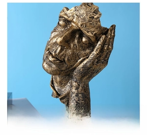 Close-up of golden abstract thinker statue with detailed vintage cracked rock texture