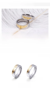 Detail showing Forever Love engraving and small diamond on silver-gold couple rings