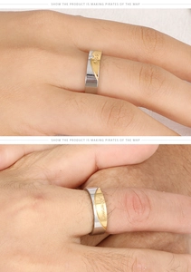 Detail of couple rings in gold and silver tones with Forever Love engraving and zircon