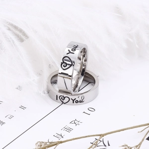 Silver stainless steel couple rings with I Love You engraving on white feathers