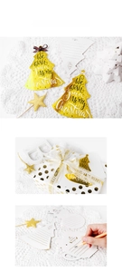 Detail showing gold foil Christmas tree card with merry Christmas greeting and ribbons