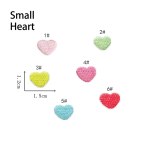 Detail of mini colorful heart embroidery patches with self-adhesive backing in six vibrant colors