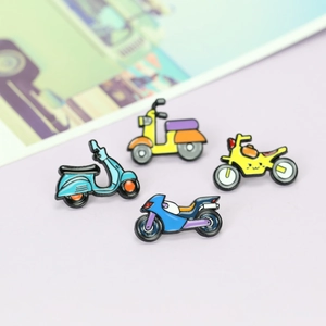 Set of four colorful cartoon motorcycle enamel pins on a light purple surface