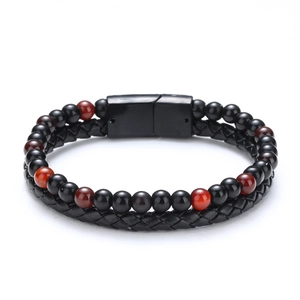 Macro shot of double-layer bracelet with braided leather, tiger eye beads and magnetic clasp