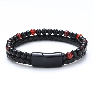 Detail of multi-layer braided leather bracelet with tiger eye stones and magnetic clasp