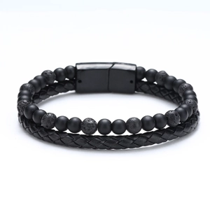 Detail of men's leather bracelet with matte black beads, lava stones, and magnetic clasp