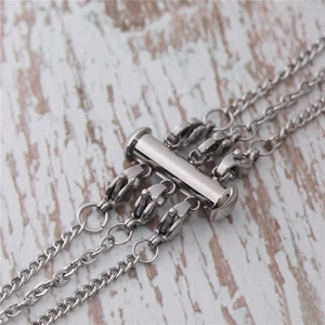 Detail of a 3-strand stainless steel necklace spacer clasp with tube lock mechanism