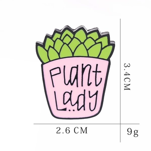 Cartoon succulent enamel pin in pink pot with PLANT Lady text and dimensions 3.4cm by 2.6cm