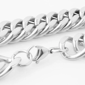 Detailed macro view of silver double-link Cuban chain necklace with lobster clasp