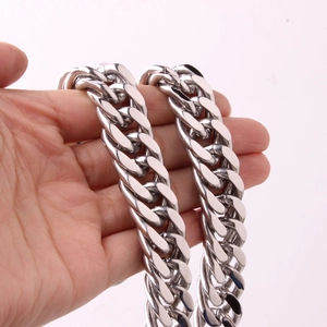 Close-up of classic silver double-buckle Cuban link necklace in polished stainless steel