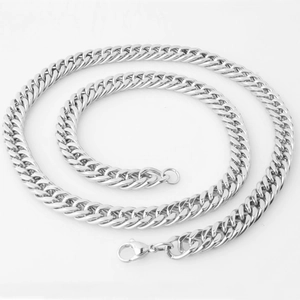 Detailed close-up of a silver cuban link chain necklace with a lobster clasp closure
