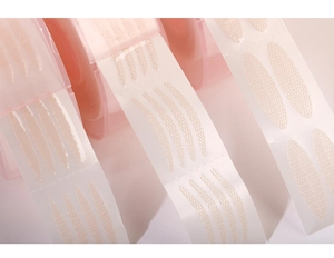 Close-up of three shapes of lace mesh double eyelid tape in a roll packaging
