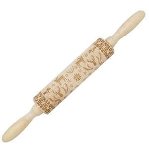 Macro view of Christmas deer and snowflake patterns on a wooden rolling pin
