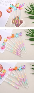 Close-up of creative cartoon gel pens with colorful unicorn and swan silicone toppers