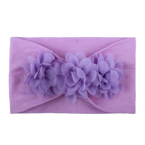 Detail of purple chiffon flowers on a soft nylon elastic headband for baby girls