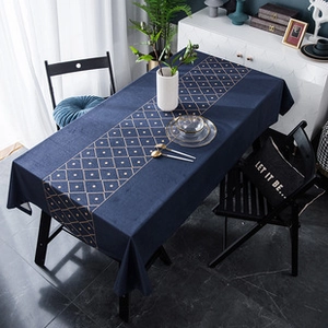 Detail of dark blue linen tablecloth with golden diamond pattern decorative band