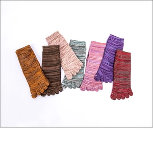 Detailed overhead view of multiple colors of knitted cotton yoga five-toe socks