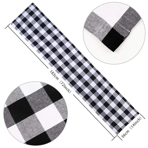 Detailed view of black and white plaid woven Christmas table runner with size dimensions