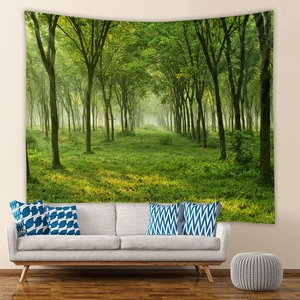 Detail of bohemian forest tapestry with sunlight landscape hanging above a modern sofa