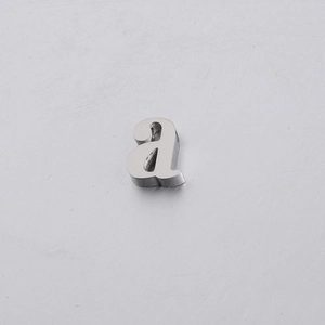 Macro shot of silver mirror-finish stainless steel letter a hole bead on metal background