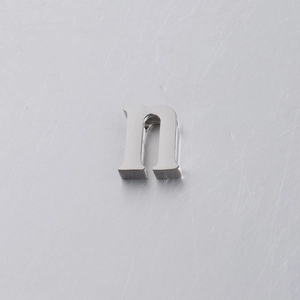 Macro shot of 10mm mirror polished stainless steel alphabet bead with letter N engraving