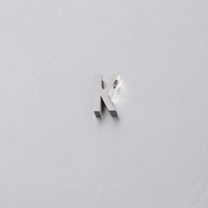 Detailed close-up of 10mm mirror polished stainless steel letter K spacer bead charm