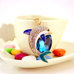 Sparkling blue crystal dolphin keychain with rhinestones on a gold metal handbag charm