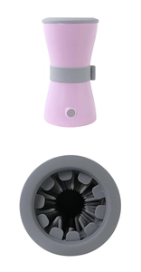 Close-up of pink electric dog paw cleaner with soft silicone bristles and power button