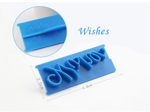 Macro detail of blue plastic fondant stamp showing embossed letters for DIY baking decoration