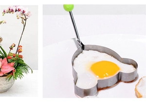 Macro detail of bear-shaped stainless steel egg mold with green handle during cooking