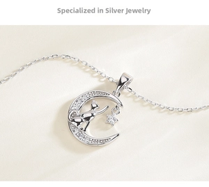 Macro shot of 925 silver moon and cat pendant with sparkling zircon star details