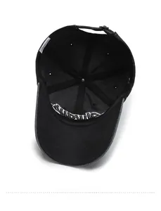 Internal view of black denim baseball cap with six-panel stitching and adjustable metal buckle