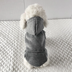 Back view of a small white dog wearing a grey fleece hooded sweatshirt for pets