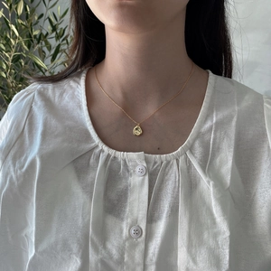 Elegant 925 sterling silver gold necklace with organic drop pendant on female model