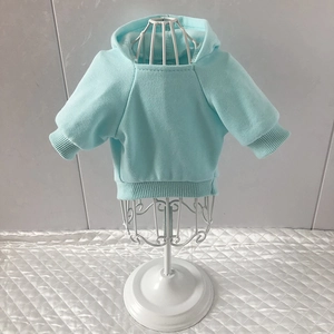 Detail of light blue pet hoodie with ribbed cuffs and hem on white display stand